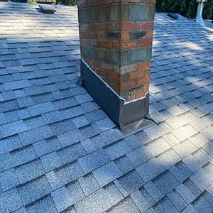 High Definition Roofing worker looking at and inspecting a new one-story high deck they built from ground level